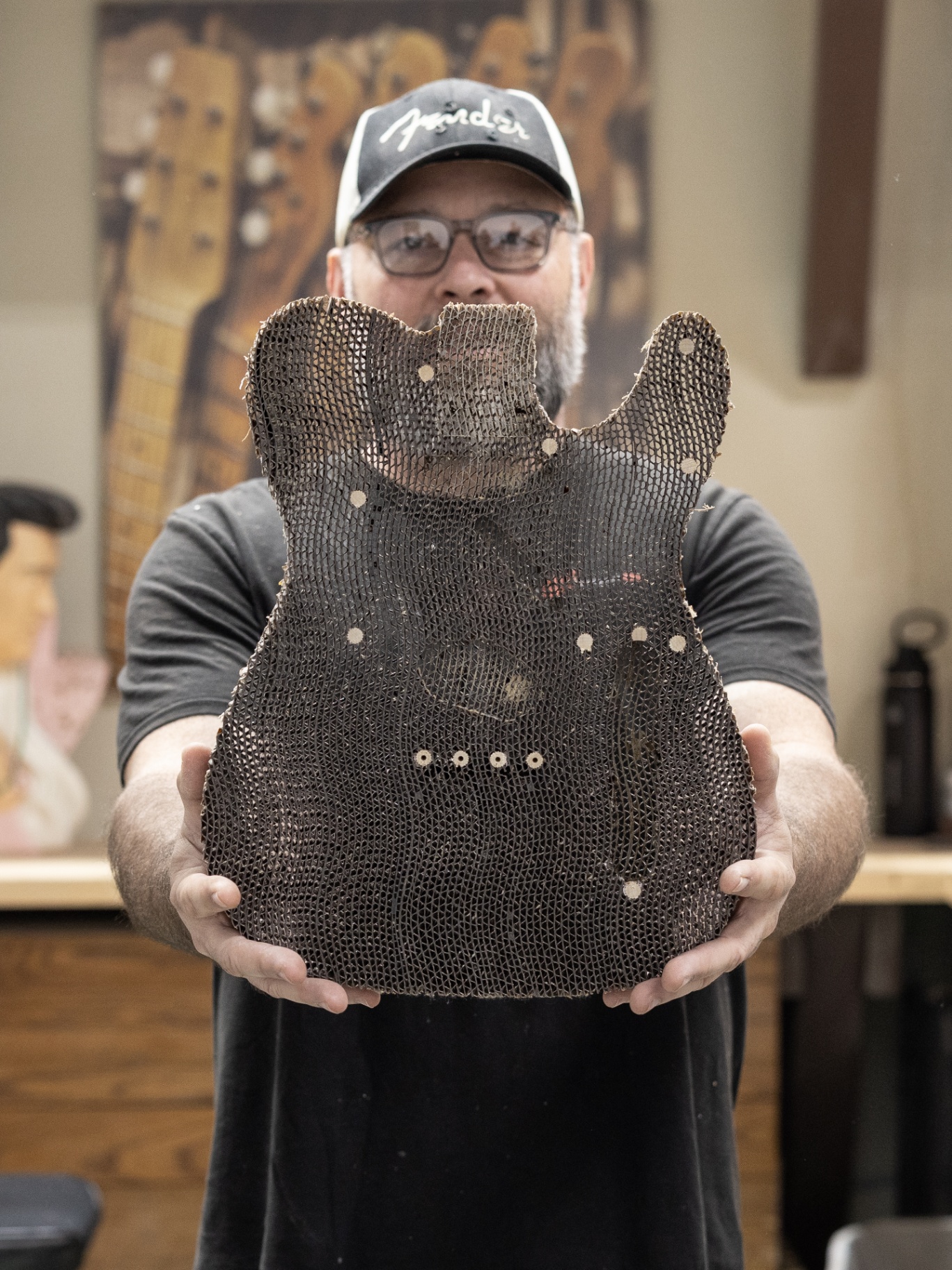 Fender master builder Paul Waller holding up the raw laminated cardboard Telecaster body blank
