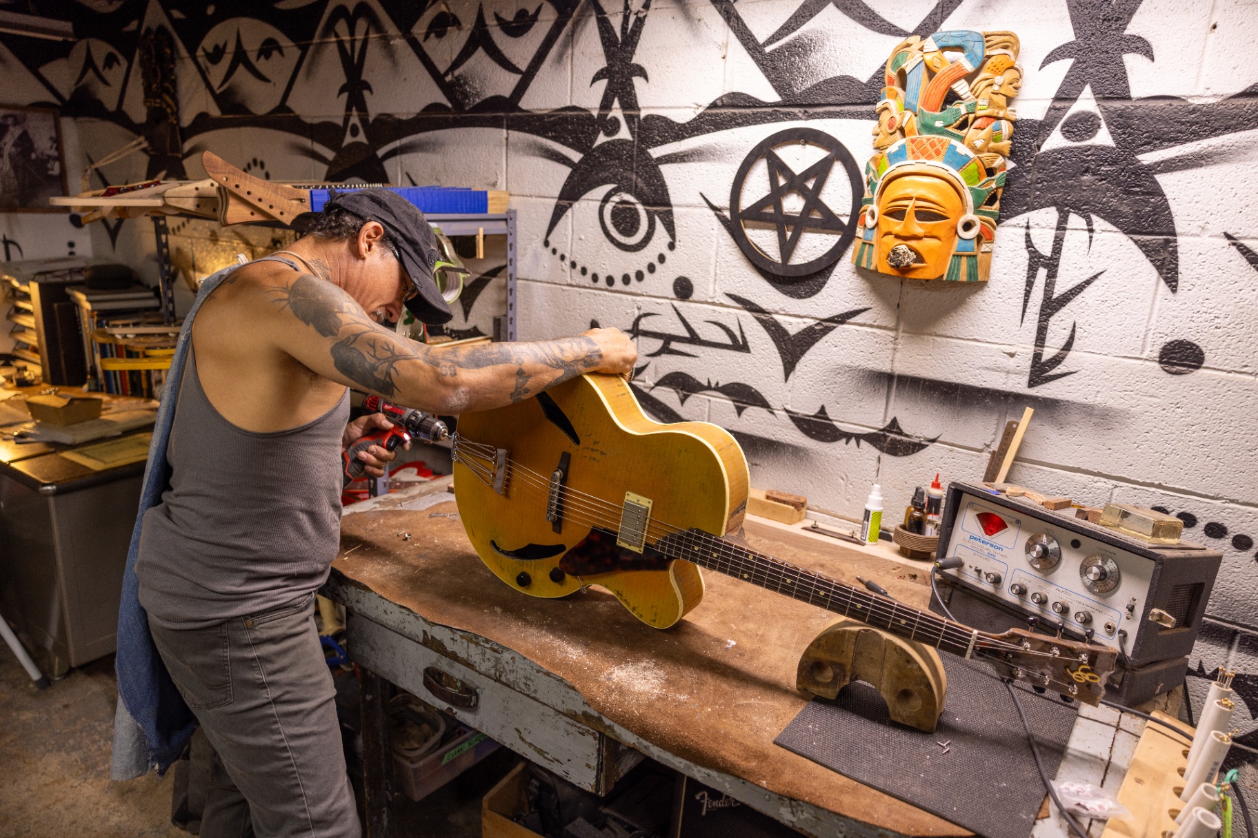 Final drilling and detail work on the finished cardboard archtop