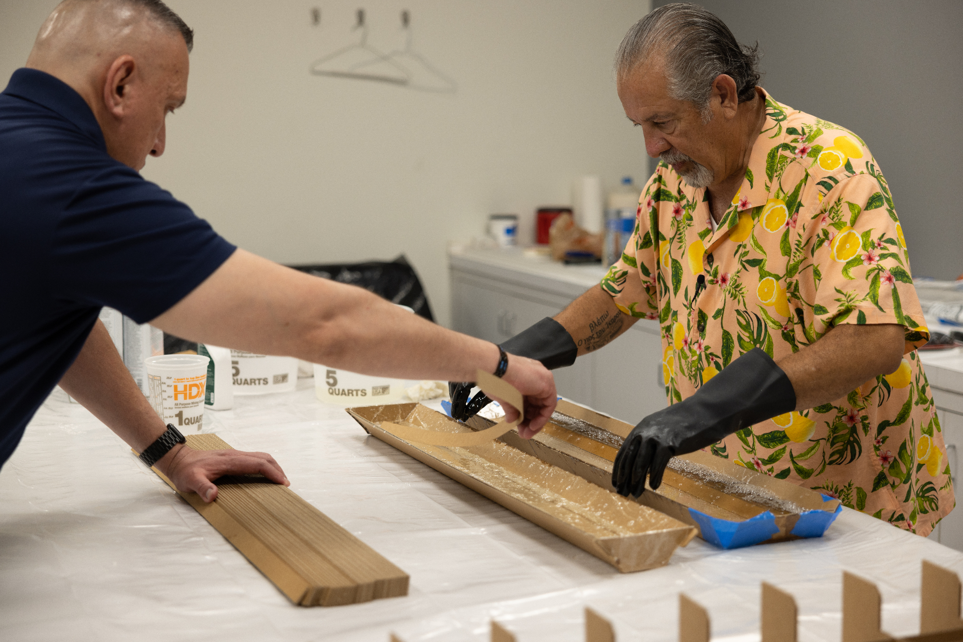 Resin being applied to the layered cardboard neck blank