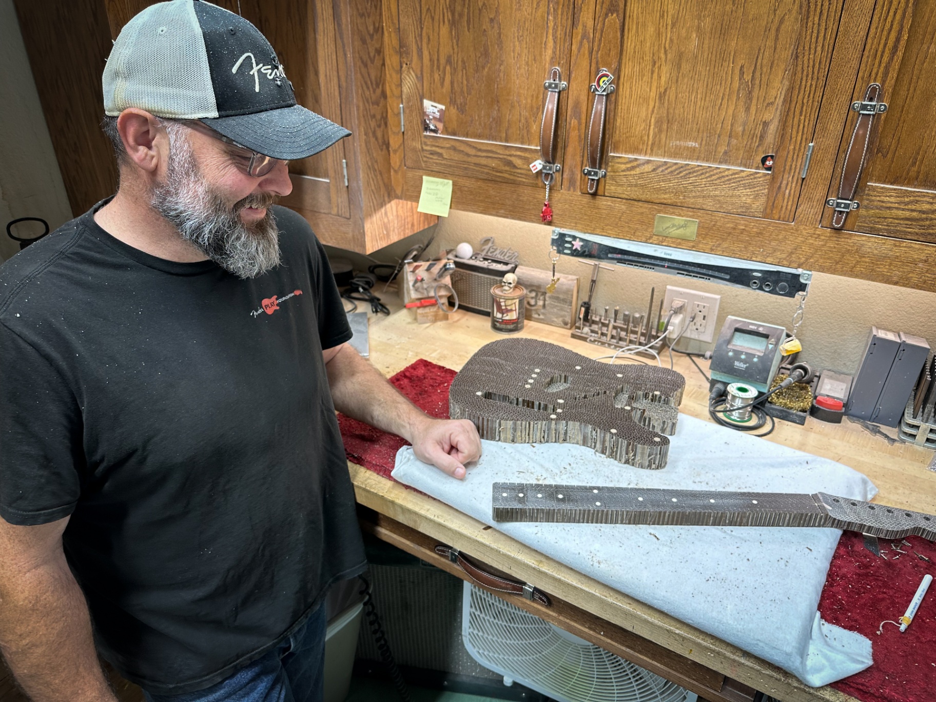 Paul Waller at the Fender bench with the routed cardboard Telecaster body and neck