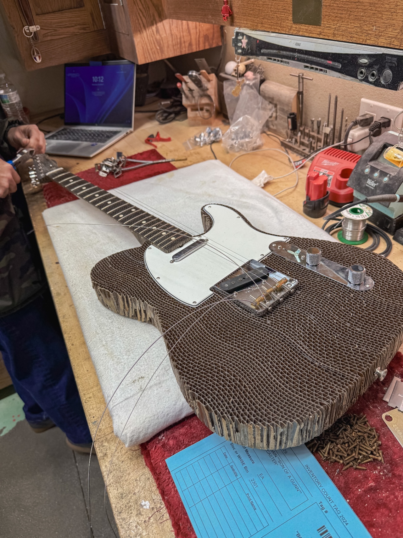Cardboard Telecaster mid-assembly with pickguard, bridge, and pickups mounted